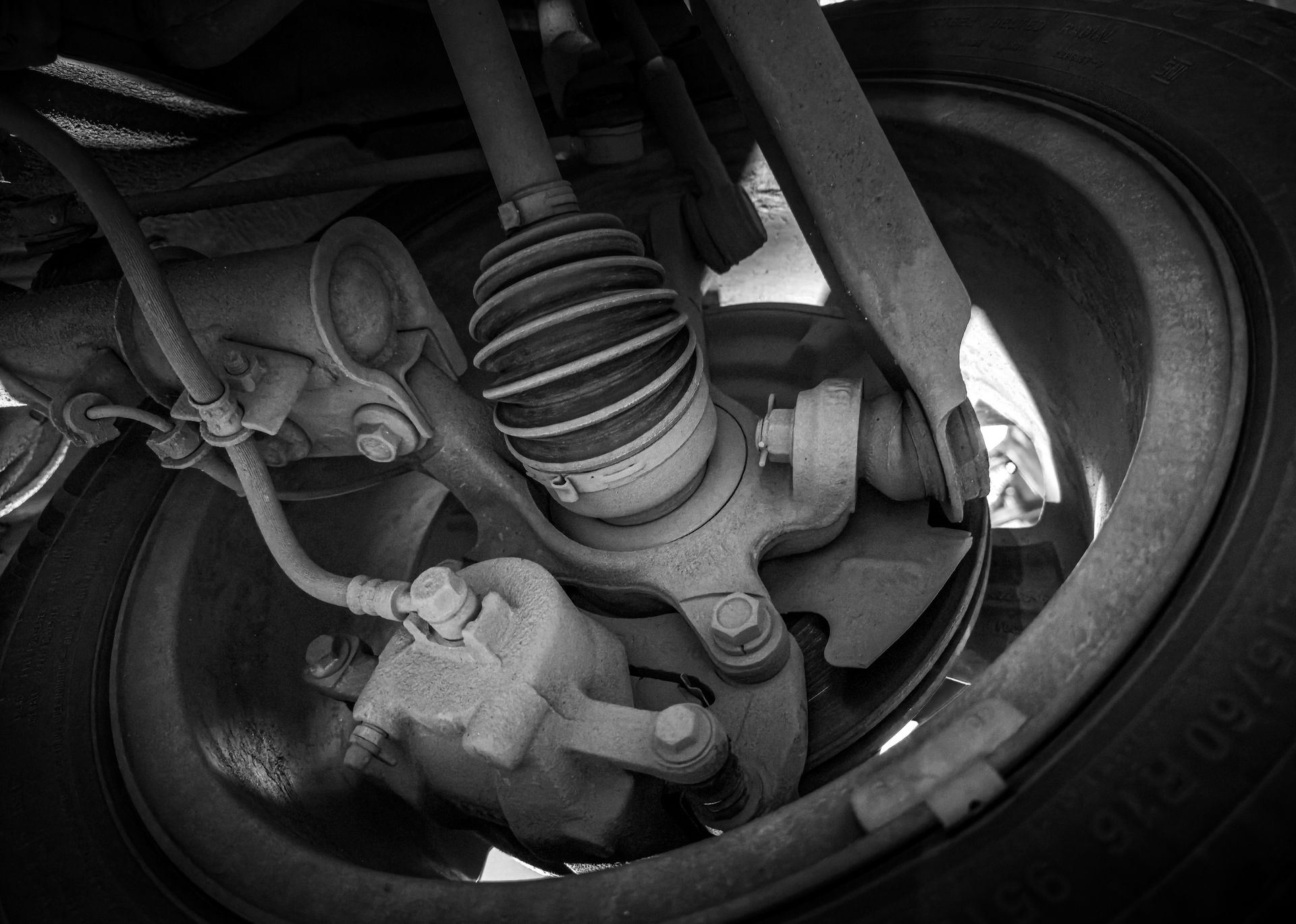 Close-up view of a car's suspension system and wheel.